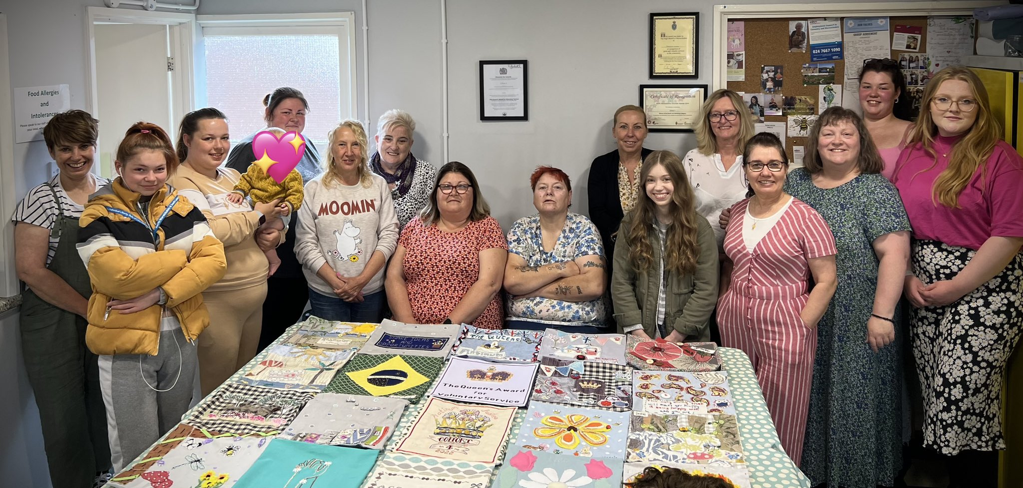 The Cohort4 women's group with their work-in-progress textile wall hanging.